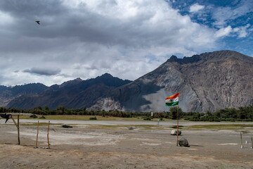 the river with blue sky and sandstone mountains in nubra valley, leh ladakh, india