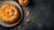 © Levan - Small upside down puff pastry cake with apple on a plate top view web banner