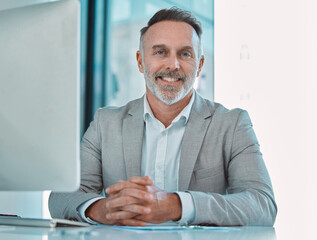 Poster - Office, portrait and mature man at computer with confidence, smile and professional at consultancy. Advisor, project manager or happy businessman at desk for online support in business development
