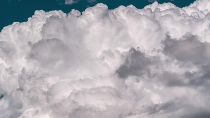timelapse of dense white clouds whirling in the dark blue sky, capturing a mesmerizing weather patte