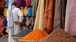 © Paul - bustling Moroccan market with richly textured fabrics and a rainbow of spices