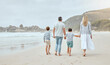 © peopleimages.com - Parents, children and holding hands at beach with back, walk or bonding with love on vacation in summer. Father, mother and kids on holiday for connection, embrace or together with family in sunshine