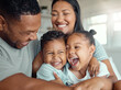 © David/peopleimages.com - Parents, children and laughing or having fun together for bonding, happy relationship and love in home. Mother, father and hug or tickling kids with comedy joke, crazy games and morning in apartment