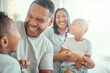 © David/peopleimages.com - Happy, family and laughing in home with children, excited and funny joke with father or son bonding for game. Woman, girl and hug in apartment bedroom with care, fun and weekend break for comedy