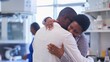 © Anna - A couple hugging a doctor in a lab, expressing their gratitude for the successful test tube baby process