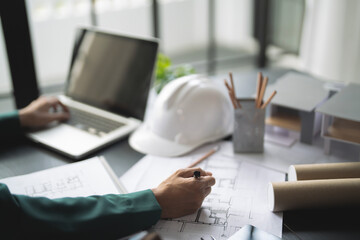 Fototapete - Architects interior designer hands working with Blue prints and documents for a home renovation for house design
