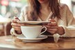© Anna - Woman using digital tablet with cup of coffee on table