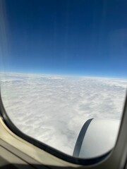 Wall Mural - Beautiful blue sky with fluffy clouds, view from plane window