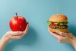 © Andrii  - Hand Holding Healthy Apple vs. Fast Food Hamburger