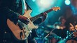 © Shozib - Musician performs on stage with a white electric guitar under blue stage lights