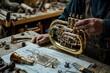 © Thanyaporn - The photo showcases a musical instrument designer in the process of assembling a new brass instrument. The workshop is filled with metalworking tools, parts, and blueprints. The designer is
