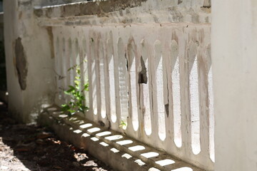Aufkleber - A white fence with round holes in it.