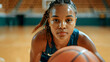 © Tanya - Determined African girl playing basketball on an indoor court, showcasing athleticism and concentration in a competitive game.