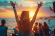 © Rattanapon - Young woman with hat at summer beach party music festival raised hands in the air, enjoy the life.