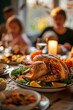 © ALL YOU NEED studio - blurred photo of family gathered around the table for thanksgiving dinner with focus on the golden baked turkey in the center and side dishes, warm light from the window in the background.cozy,festive