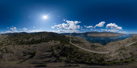 Wall Mural - Aerial Panoramic View of Highway in Desert Landscape with Mountains and Lake.