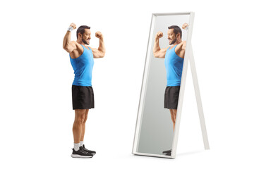 Wall Mural - Fit man in sportswear looking at his muscles in a mirror