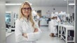 © RPL-Studio - woman scientist with blonde hair, is standing confidently in a modern laboratory setting. She is dressed in a white lab coat, wearing glasses, and has a bright, smiling expression
