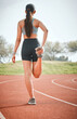 © DavisShared/peopleimages.com - Girl, stretching leg and athlete on track, outdoor warm up and prepare for start of running. Female person, back and getting ready for marathon training, flexible and muscle for sports performance