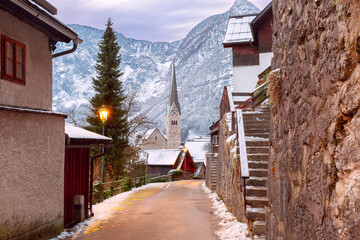 Wall Mural - View of the famous Austrian village of Hallstatt with snow-capped mountains in the background, Austria