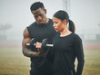 © DavisShared/peopleimages.com - Sports, weights and personal trainer with woman in nature for arm strength, muscles and tone. Fitness, fog and male instructor helping female athlete with dumbbell for lifting exercise in field.