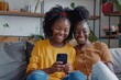 © Coconut Design - African girl and young mother sit on sofa with smartphone, enjoy video conference talk event with family, smiling watching funny online content, amusing videos. Modern technology, fun, Generative AI