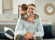 © peopleimages.com - Happy, son and hugging dad in portrait, peace and single parent love for boy in living room. Daddy, kid and embrace for security on couch for care in childhood, relationship and comfortable home