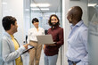 © ADDICTIVE STOCK - Diverse team discussing project with laptop