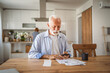 © Miljan Živković - Senior man have contact less payment scan invoice on mobile phone