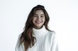 © larrui - Smiling woman in white turtleneck sweater against a white background. Studio portrait photography. Winter fashion and cozy concept