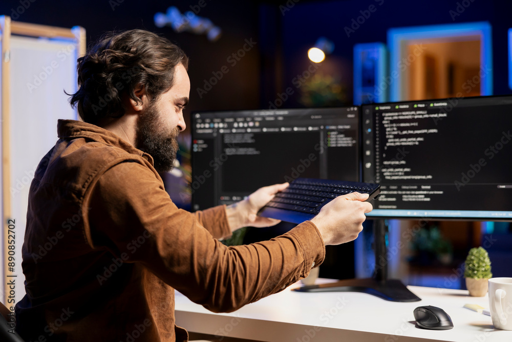 Angry programmer trying to smash keyboard in frustration after failing ...