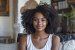 © Just Bella - people, race, ethnicity and portrait concept - happy african american young woman sitting on sofa at home, Generative AI