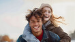 © EliteStockPhotos - Joyful moment of friendship as a young man carries a smiling woman on his back outdoors, perfect for lifestyle, relationships, and youth marketing.