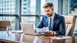 © Selene Studio - Businessman conducting a meeting with papers and laptop on table, businessman, meeting, discussion, papers, laptop