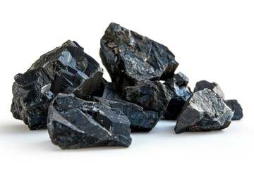 Poster - A close-up shot of a stack of dark rocks on a clean white surface