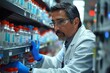 © fotofabrika - Male Scientist Wearing Safety Glasses and Gloves Reaches for Sample Bottles on Shelf in a Laboratory