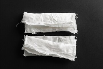 Aufkleber - Two pieces of white fabric lying on a black surface