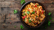 © Sinclair - Bowl of chicken biryani on a wooden background from above