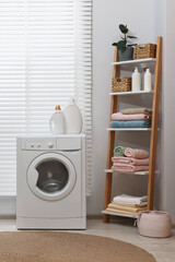 Canvas Print - Washing machine, detergents, towels and shelving unit in laundry room