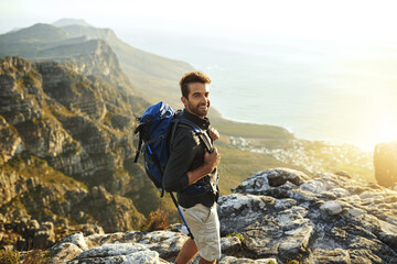 Poster - Man, mountain and backpacking for outdoor portrait, travel and hiking in nature for tourism journey. Male person, trekking and athlete for fitness, explore adventure and exercise for holiday workout