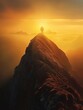 © Pattypatt - Silhouette of a person standing on a mountain peak at sunrise.