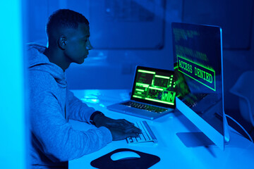 Fototapete - Theft, screen or black man hacking computer for cybercrime, malware or phishing for stealing online data. Hacker, night and software update on pc with coding expert or access denied web notification