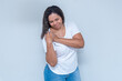 © Anna Quelhas - young woman in white shirt with shoulder pain, a space for your product or message, person, advertising concept, mockup space