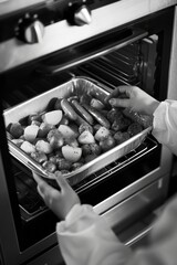 Wall Mural - Person removing cooked meal from oven