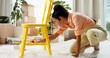 © peopleimages.com - DIY, chair and yellow with painter woman in living room of apartment for creative renovation of furniture. Art, craft and painting with person in apartment for property or real estate maintenance