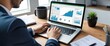 © Qbertstudio - A professional man analyzes business data on a laptop, showcasing charts and growth statistics in a modern office setting.