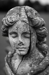 Poster - weathered stone statue with closed eyes