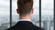 © Balaraw - businessman looking out over city skyline