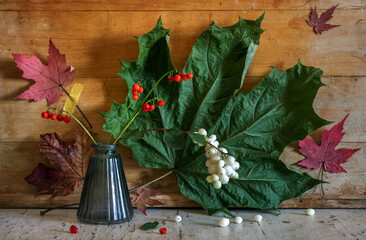 Wall Mural - A small bouquet of snowberry branches with berries and red lily of the valley berries.