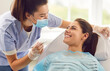 © Studio Romantic - Doctor dentist or nurse conducting a medical checkup of a patient in a clinic, using a dental instrument. Oral care examination improving dental health, providing quality dentistry service.